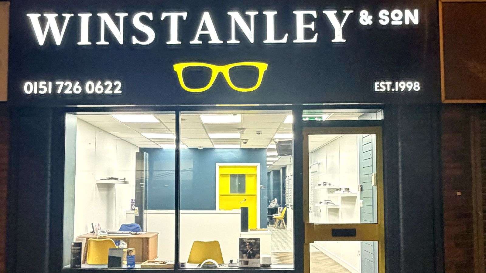 Winstanley & Son on Park Road, Liverpool, lit up at night